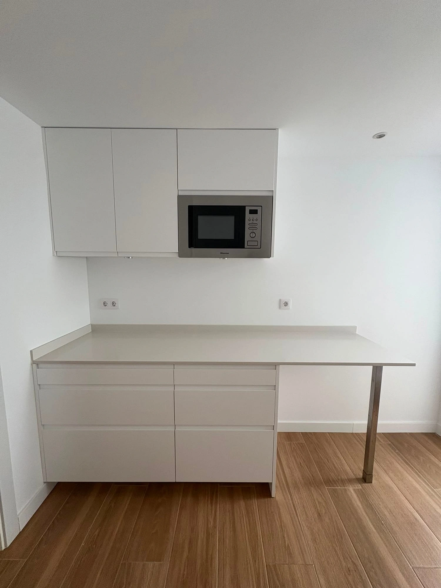 Second run of the kitchen with the breakfast bar, drawers and microwave built into the tall unit